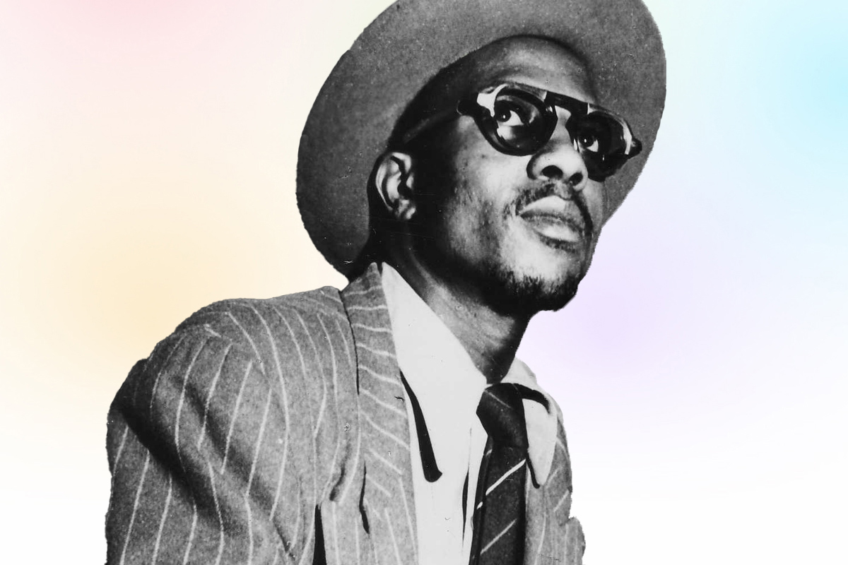 Headshot of Thelonious Monk in a suit, looking over top of the camera
